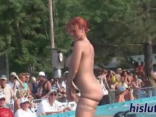 Ravishing redhead performs striptease in publik